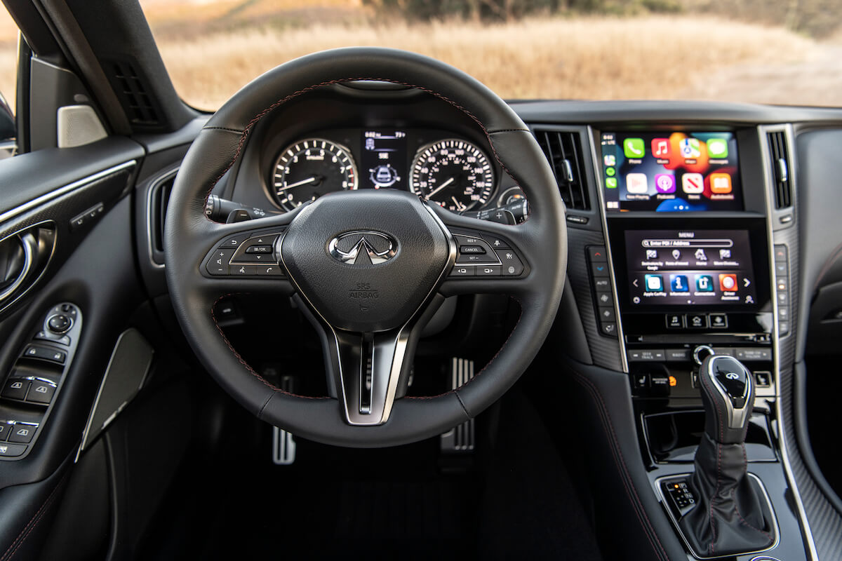 A red 2023 Infiniti Q50S interior from the view of the driver