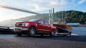 A 2023 Ford F-150 with an EcoBoost engine tows a trailer.