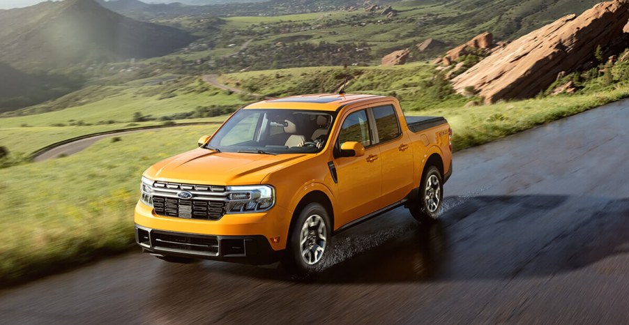 A yellow 2023 Ford Maverick is driving down the road