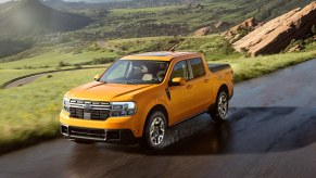 A yellow 2023 Ford Maverick Lariat is driving down the road as a small truck.