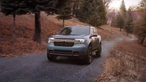 A Ford Maverick hybrid truck is driving on the road.