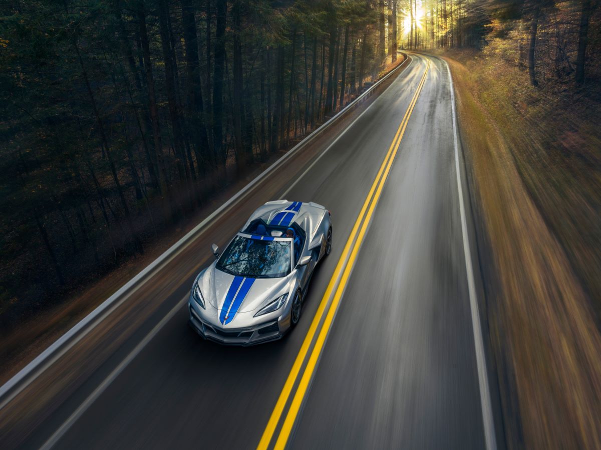 A 2024 Chevy Corvette E-Ray 3LZ Convertible hybrid sports car in Silver Flare color with an Electric Blue stripe