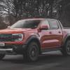 A 2024 Ford Ranger Raptor driving down an open road.