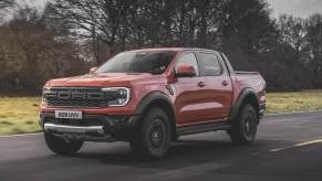 A 2024 Ford Ranger Raptor driving down an open road.