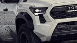 White 2024 Toyota Tacoma off-road throwing dirt