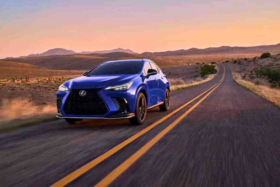 THe 2024 Lexus NX 450h+ in blue on a desert road at twilight.