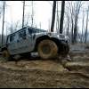 A Hummer off-road vehicle shows how to use a four-wheel drive system on a muddy off-road course.