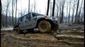 A Hummer off-road vehicle shows how to use a four-wheel drive system on a muddy off-road course.