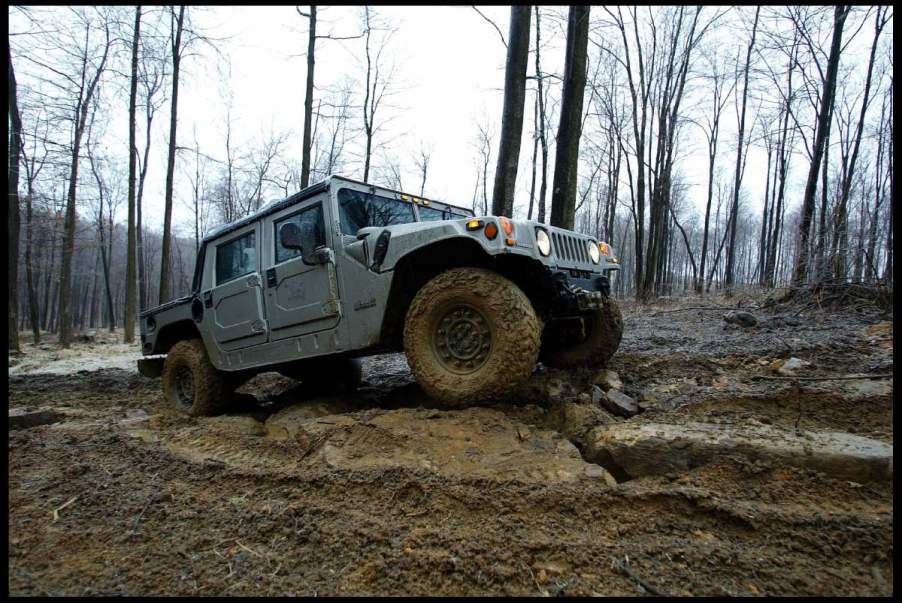 A Hummer off-road vehicle shows how to use a four-wheel drive system on a muddy off-road course.