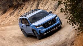 Blue 2023 Honda Pilot driving off road in the desert