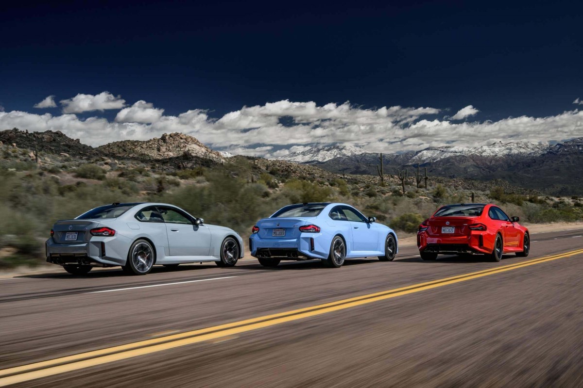 Three BMW M2 models on a highway without a turn signal in sight.