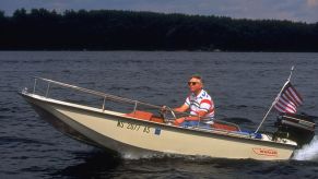 A man driving a small Boston Whaler boat.