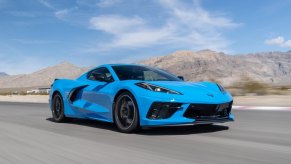 A bright blue C8 Stingray blasts across the desert.