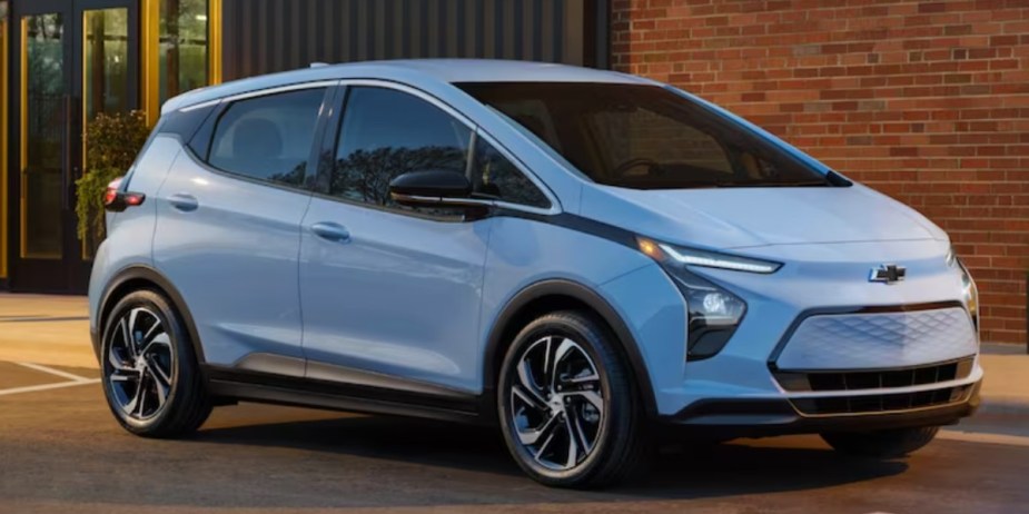 A blue 2023 Chevrolet Bolt EUV electric hatchback is parked. 