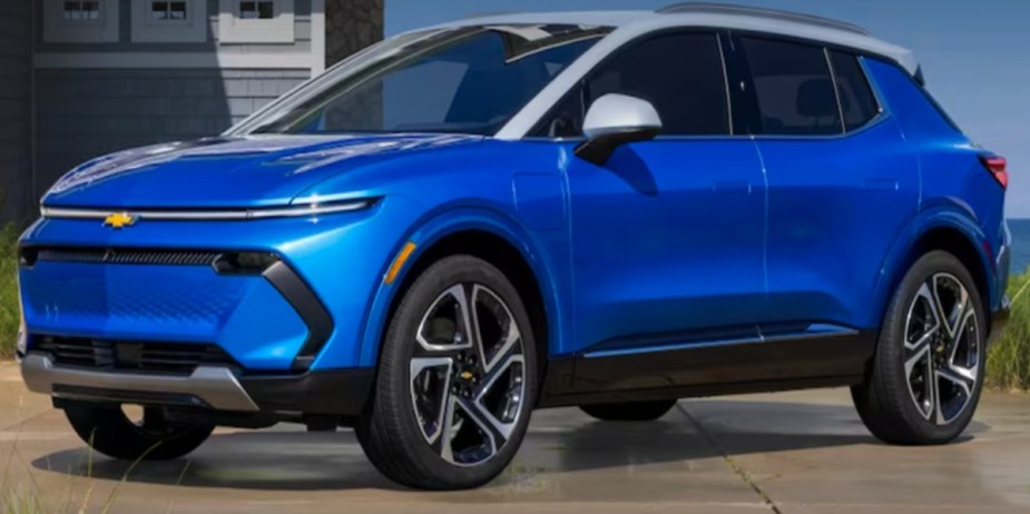 A blue 2024 Chevrolet Equinox EV small electric SUV is parked. 