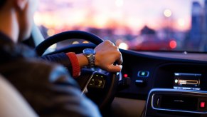 A man driving a car, which may or may not have a car immobilizer system standard