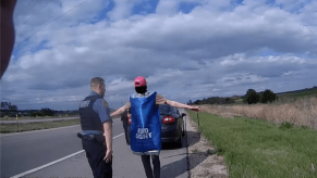 Drunk driving suspect in Bud Light costume with arms extended