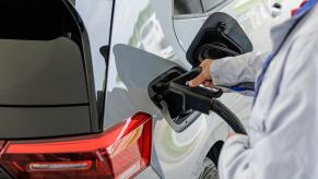 A worker demonstrates the EV charging process of Volkswagen's second generation ID.3 electric car