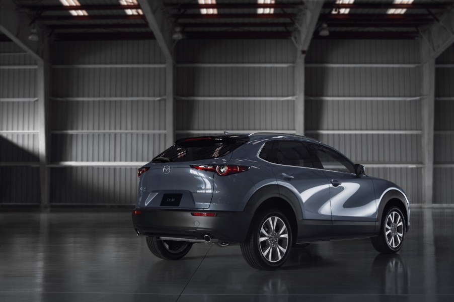 A light blue Mazda CX-30 sits in a hanger with its rear to the camera. The CX-30 is a crossover that's still great for driving.