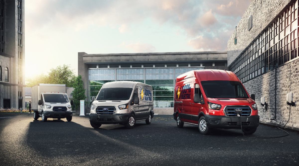 A lineup of Ford E-Transit work vans.