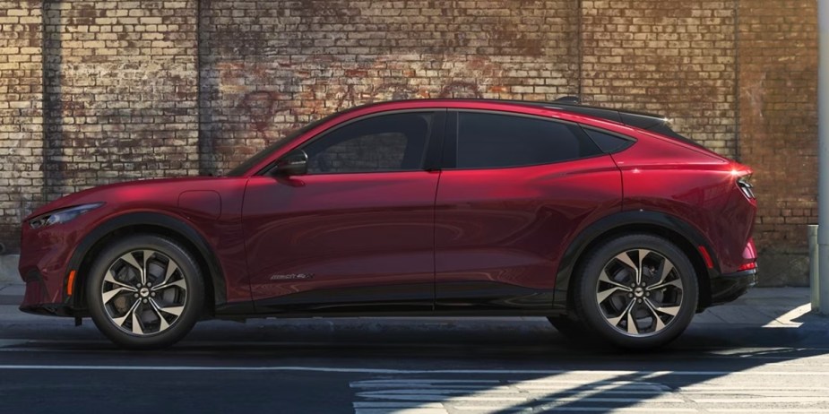 A red 2023 Ford Mustang Mach-E small electric SUV is parked. 