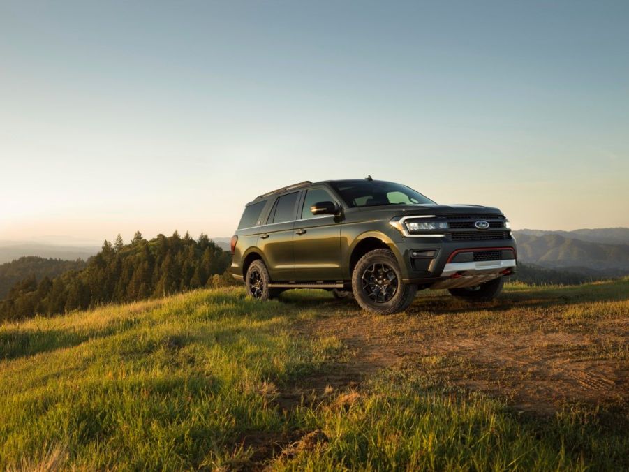 A green Ford Expedition Timberline drives an off-road trail at dusk. The Ford SUV saw sales rise dramatically in the first quarter of 2023.