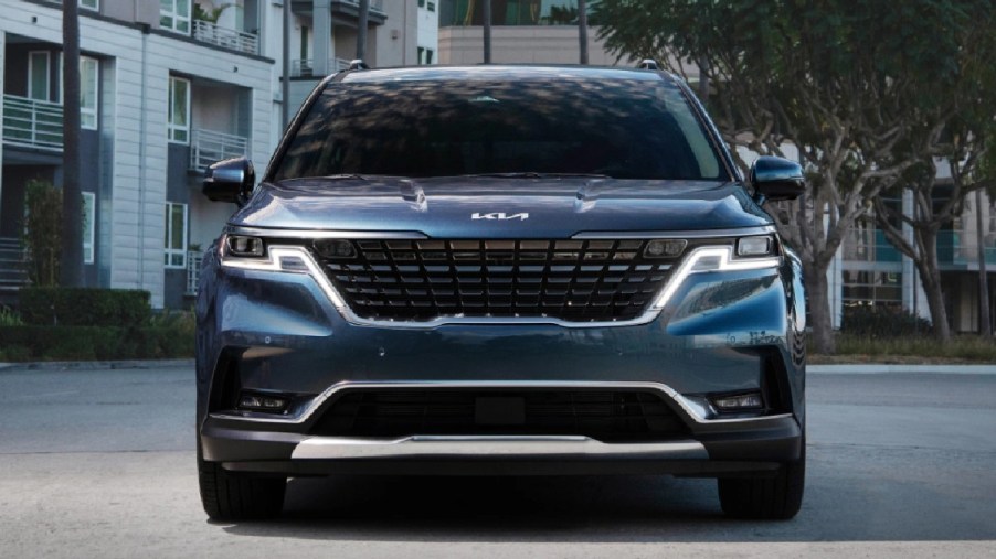 Front view of blue 2024 Kia Carnival minivan