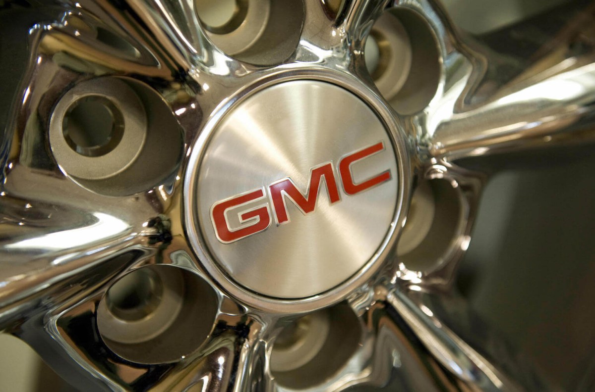 The GMC Typhoon logo on a wheel for sale in a GM showroom