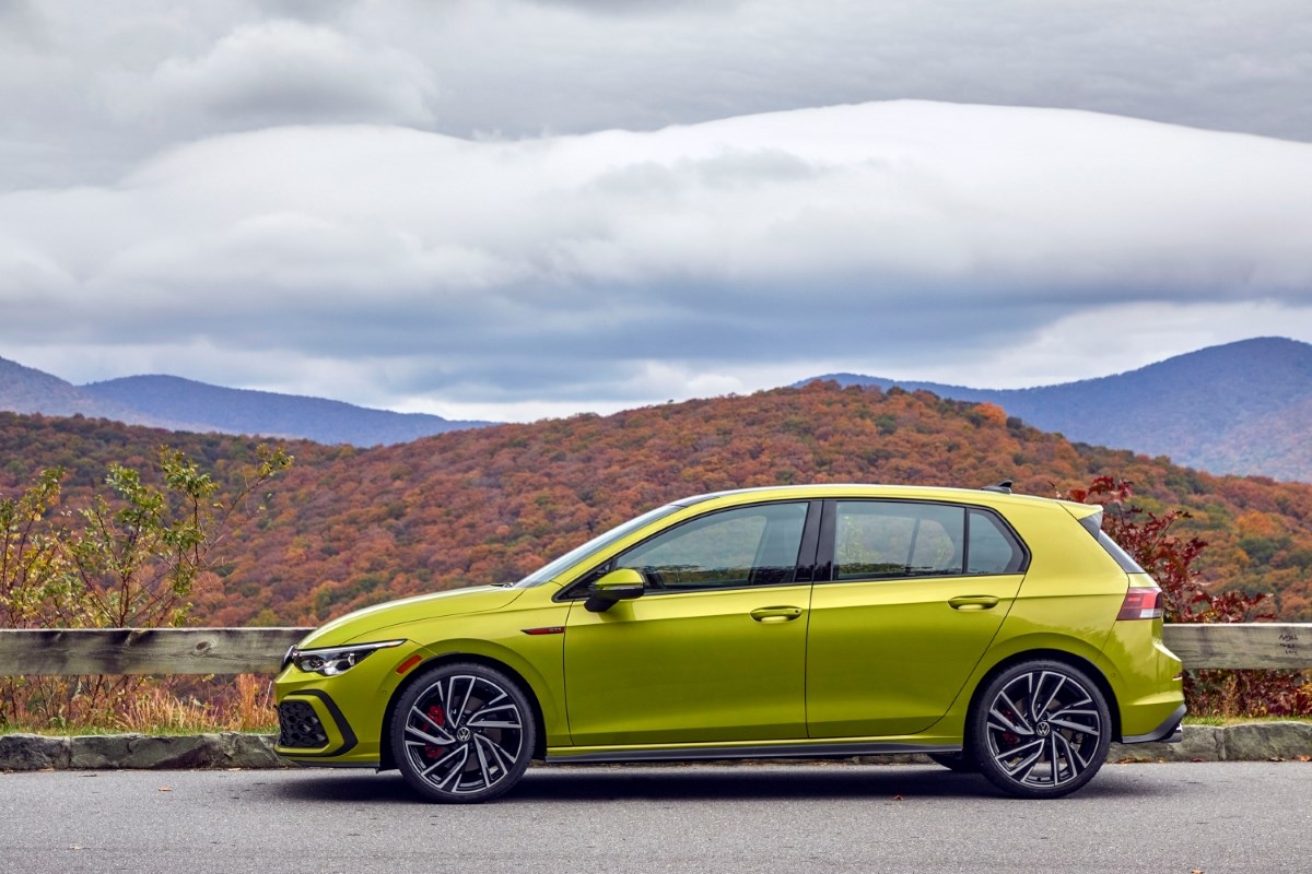 Golf GTI in green parked on a road.