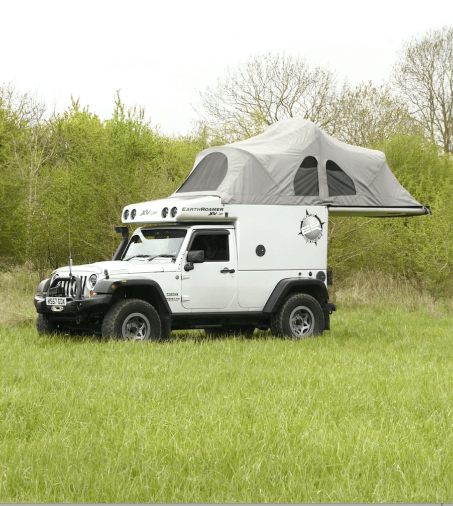 The roof tent unfolded showing the camp setup of the Jeep Wrangler camper.