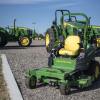 John Deere tractors sitting on asphalt