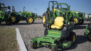 John Deere tractors sitting on asphalt