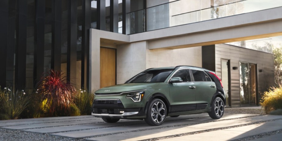 A green 2023 Kia Niro hybrid SUV is parked. 