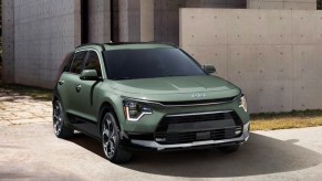 A green 2023 Kia Niro subcompact hybrid SUV is parked.