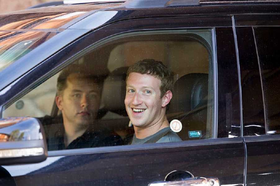 Billionaire Mark Zuckerberg smiles in a car.