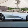 A McLaren Speedtail parked on a pedestal at an automotive concourse show