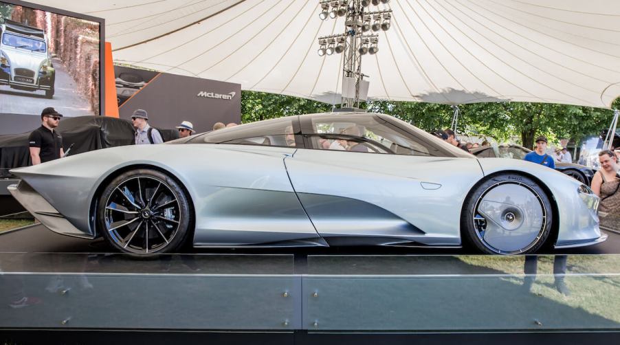 A McLaren Speedtail parked on a pedestal at an automotive concourse show