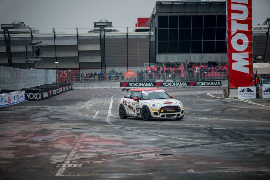 The front view of a Mini Cooper on a race track