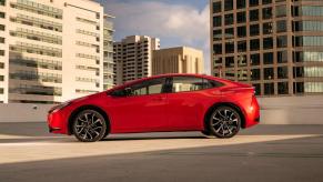 A side profile shot of a 2023 Toyota Prius Prime XSE plug-in hybrid hatchback on top of a parking garage