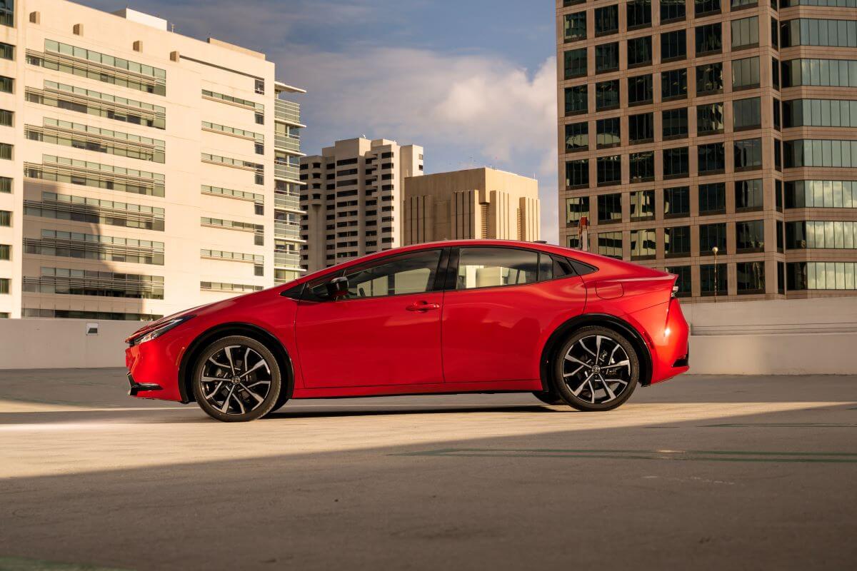 A side profile shot of a 2023 Toyota Prius Prime XSE plug-in hybrid hatchback on top of a parking garage