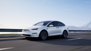 The largest vehicle in the Tesla lineup, the Model X, cruises a highway.