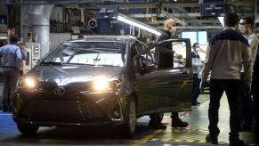 A Toyota car in an factory gets a safety inspection.