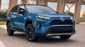 A blue 2023 Toyota RAV4 Hybrid small hybrid SUV is parked.