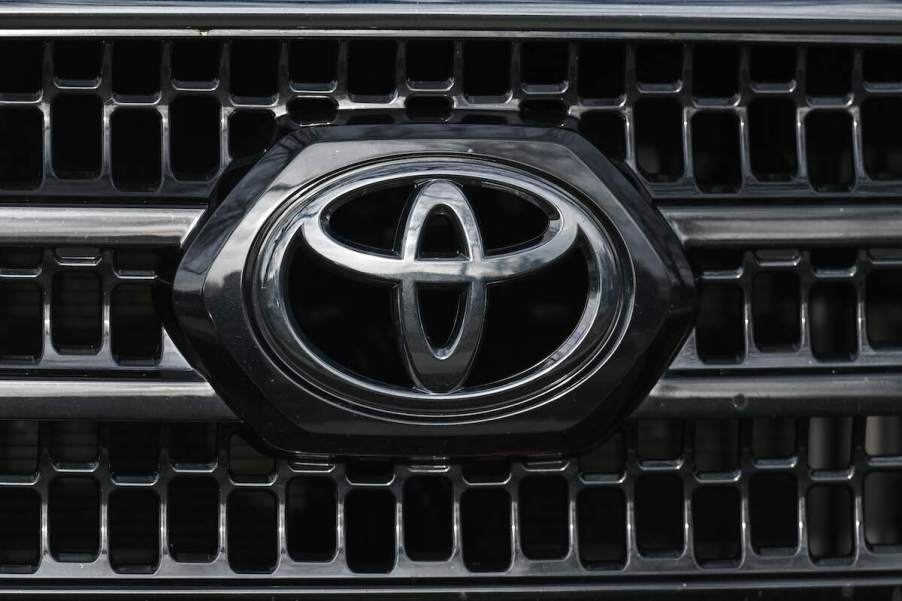 A silver Toyota logo on the grille of a car. Certain Toyota models have seen sales declines so far in 2023