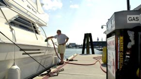 A man fueling up his Viking Yacht at a gas station.