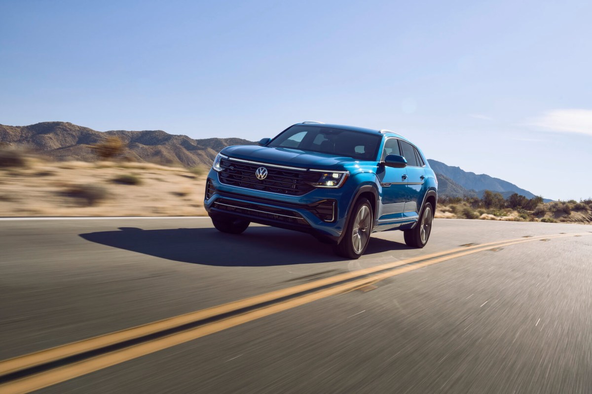 A blue 2023 Volkswagen Atlas Cross Sport on the open desert road