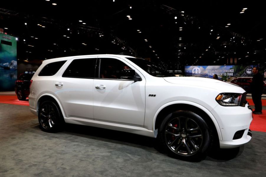 A white Dodge Durango on display at an auto show.