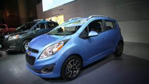 A blue Chevy Spark at an auto show.