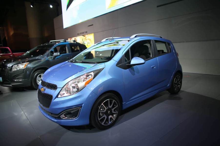 A blue Chevy Spark at an auto show.