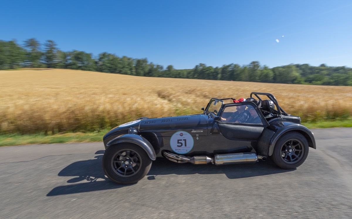 A grey Caterham Seven on a road